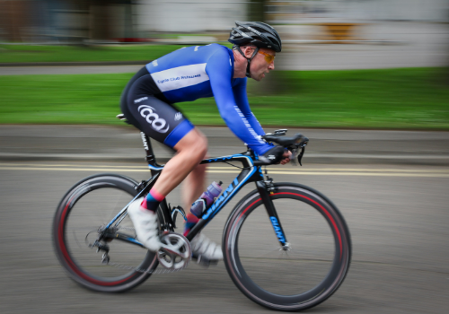 Cyclist in an aerodynamic position with a low back